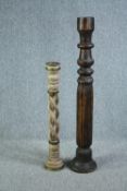 Two floor standing turned wooden candle holders. Twentieth century. H.127 cm. (largest)