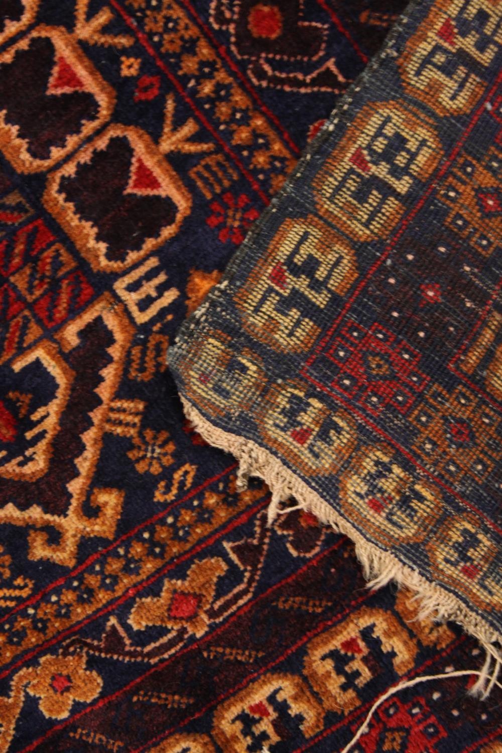 A Kazak rug with triple medallions in multiple stylised borders. L.200 W.110cm. - Image 3 of 3