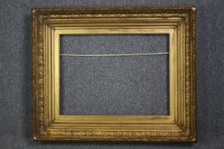A large nineteenth century giltwood and gesso frame. H.85 W.100 cm.