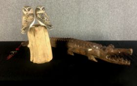 A large carved crocodile with well detailed scales and teeth and signs of age. Twentieth century but