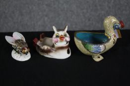 Three porcelain animals. A cat, pelican and fly. Hand coloured and with some markings on the base.