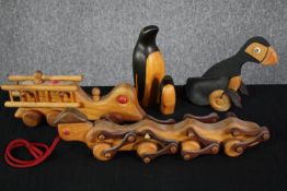 A collection of hand carved and painted mid century children's toys, including a caterpillar and