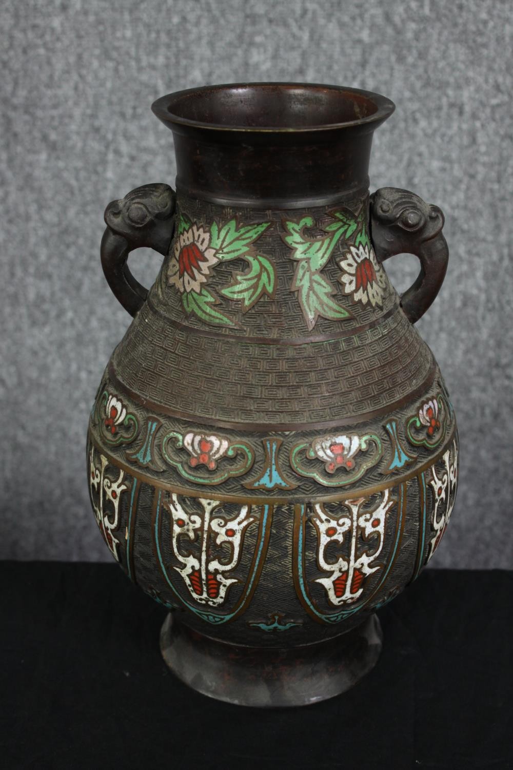 A large early 20t century Japanese Archaistic bronze Champlevé vase with twin elephant head handles.