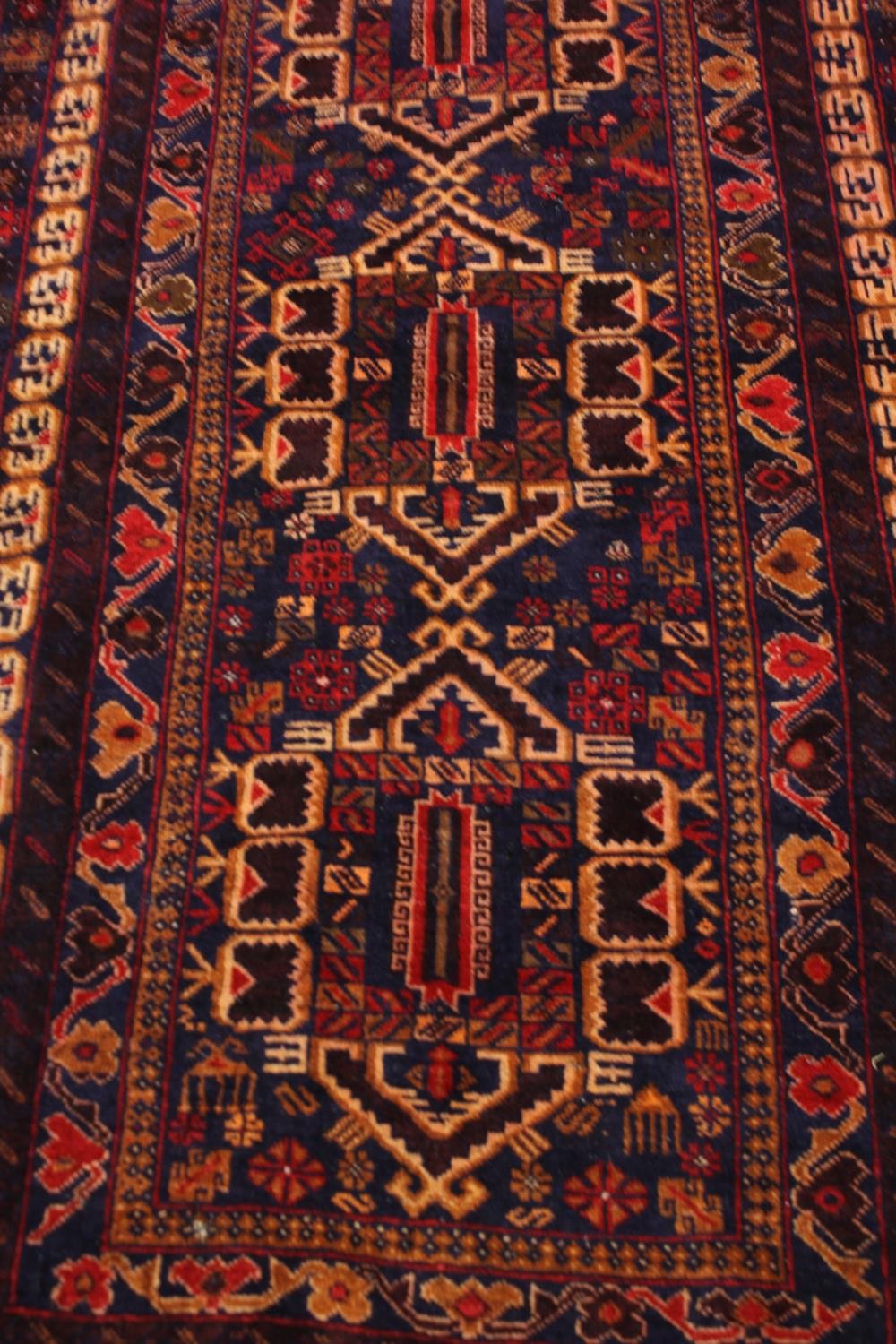 A Kazak rug with triple medallions in multiple stylised borders. L.200 W.110cm. - Image 2 of 3