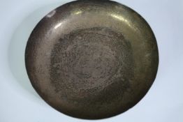 An Egyptian silver bowl with engraved stylised foliate design. Four button feet to the base. Mark to