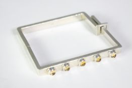 A boxed mid century G. Mantella silver brutalist style square bangle set with five round citrine