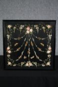 A framed embroidery. An intricate floral design on a black background. Framed and glazed. H.53 W.