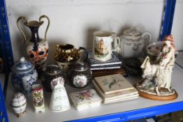 An assortment of mixed ceramics to include tiles, jugs and a vase. Roughly 25 pieces. The largest