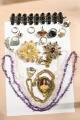 A selection of costume jewellery made up of rings, bracelets and necklaces.
