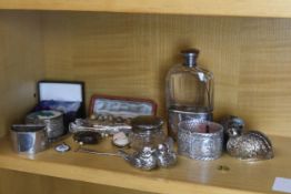 A mix of silver and silver plate items to include a silver hip flash and napkin rings. The bottle is