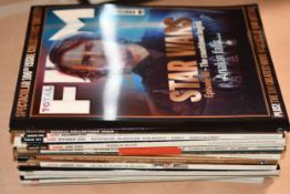 A collection of magazines including holographic-covered FHM and Empire magazines.