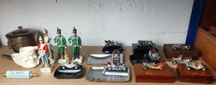Complete shelf of collectables, cars, miniature soldiers and a silver plate ice bucket.