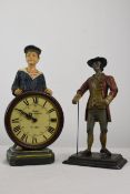 Two figures. One resin and holding a clock made by Dewberry and, the other wooden.