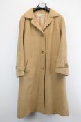 A vintage Selfridges women's long camel coat.