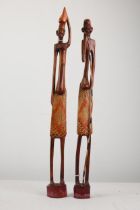 Two tribal carved figures. Hunters. 64cm high
