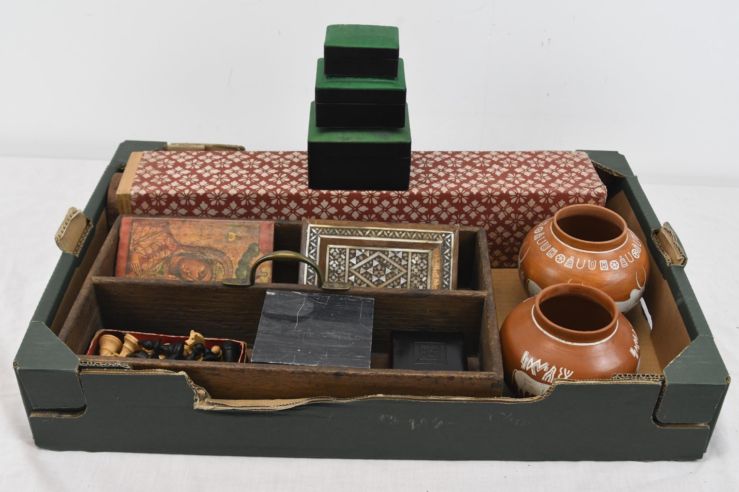 A collection of wooden boxes, an icon and two pots. One of the box is decorated with mother or