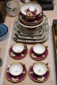 A Victorian porcelain hand painted floral four person tea set with maroon and gilded design along