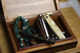 A small wooden box of miscellaneous items to include a penknife, bracelet whistle, and brooch. H.5