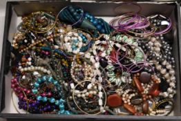 A large collection of costume jewellery to include necklaces and brackets.
