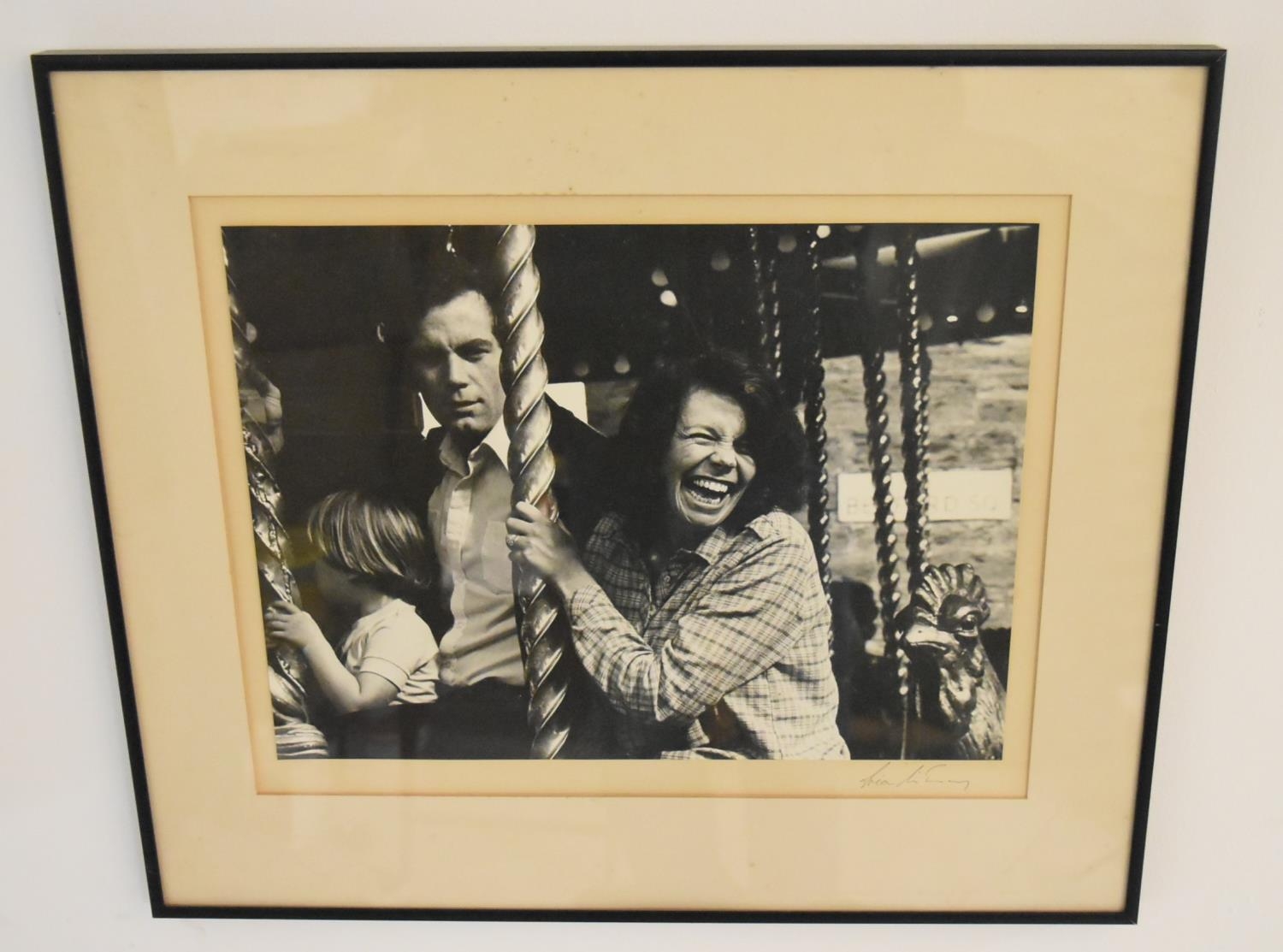 Indistinctly signed; Family at the Fair, a mounted black and white photograph, framed. H.46 W.54cm
