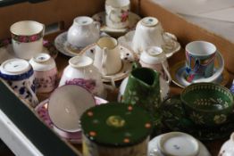 A mixed collection of china cup and saucers and milk jugs.
