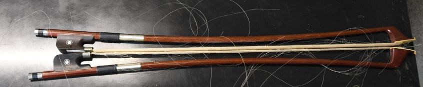 Two violin bows each measuring 80 cm long. Frayed but otherwise in good condition.