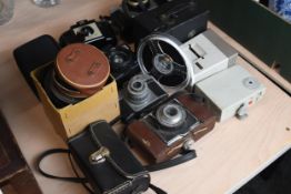 An assortment of cameras and camera equipment. To include the Kodak Brownie, Halina, Ilford and