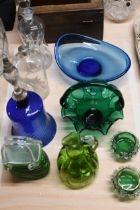 A collection of coloured art glass, including a cobalt glass hand bell, Bohemian enamelled glass