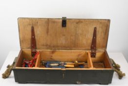 A vintage British Army Issue Wooden toolbox containing non military clamps and a saw. H.20 W.95 D.35