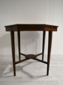 An Edwardian mahogany octagonal occasional table on tapering supports united by stretcher. H.68.5