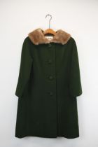 A vintage Harrod's army green women's winter coat with a mink fur collar. Label to interior.