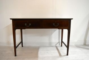 An Edwardian inlaid mahogany two drawer hall table raised on tapering supports terminating in pad