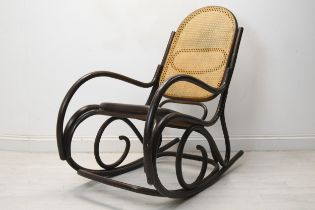 A vintage bentwood rocking chair with caned back and seat. H.110 W.55 D.110cm.