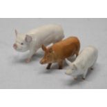 Three Beswick ceramic pigs.