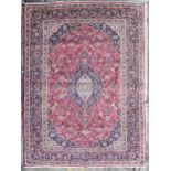 Carpet, hand knotted Persian with triple medallions within scrolling foliate spandrels and