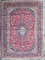 Carpet, hand knotted Persian with triple medallions within scrolling foliate spandrels and