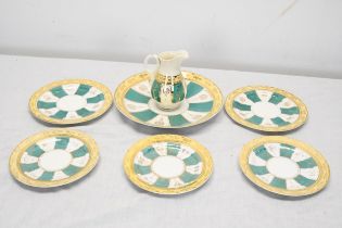 A hand painted 19th century green white and gold sunray pattern incomplete tea set. Largest plate