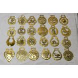 A collection of twenty four early 20th century horse brasses of various designs. x24.