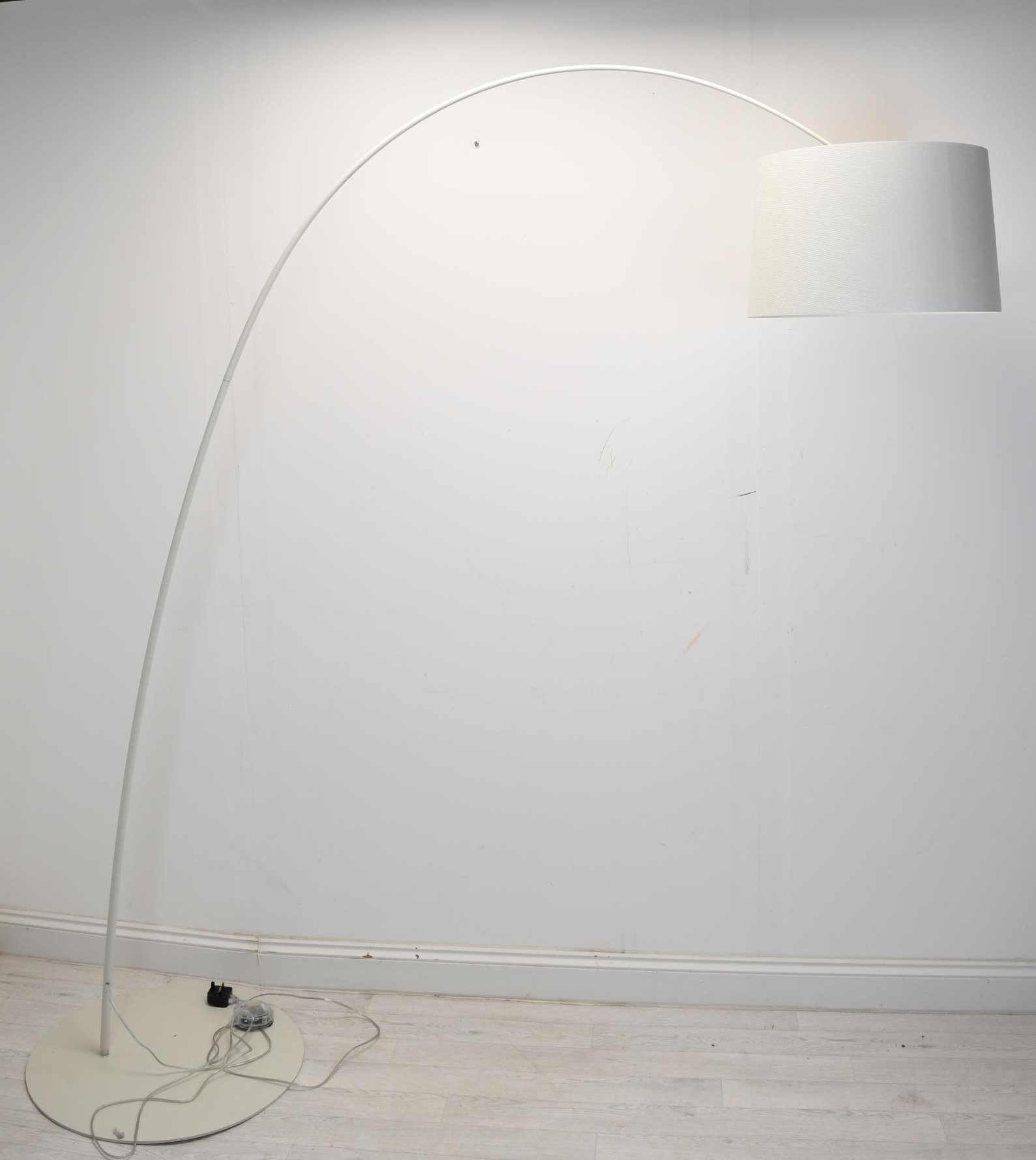 A contemporary white metal floor standing arc lamp. H.201 W.190cm.