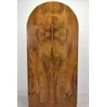 An Art Deco walnut veneered dome topped and twin door wardrobe, opening to reveal mirror, raised