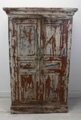 A distressed painted Eastern hardwood hall cupboard. H.129 W.84 D.42cm.
