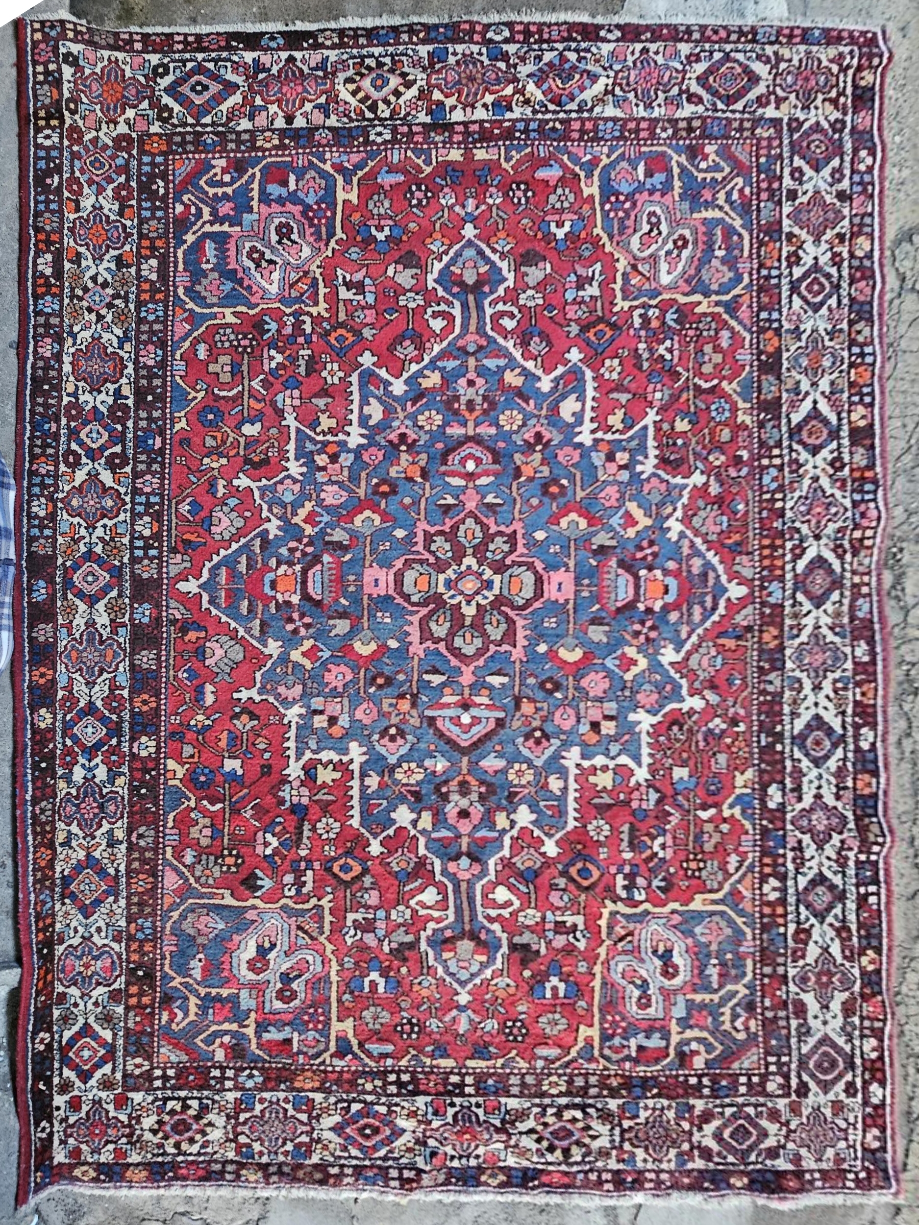 Carpet, hand knotted Persian with central sapphire flowerhead medallion on a madder ground within