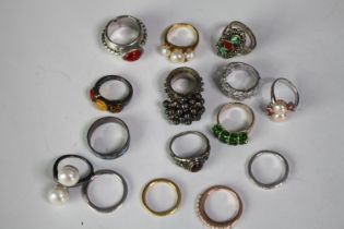 A collection of fifteen silver and silver and gem-set rings of various designs. Set with pearls,