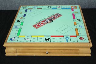 A games compendium containing Monopoly, Chess, Cluedo and Checkers. The board has some light wear