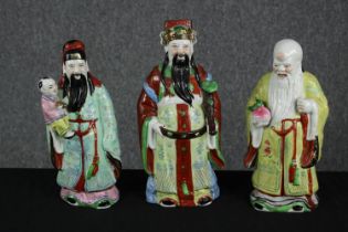Three hand painted Chinese figures. Signed on the bases with the artist's seal. Twentieth century.