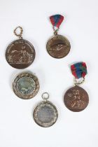 Four 19th century Napoleon III medals and a medal/brooch. Three bronze medals, one with shaking