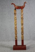 An Oriental boat mounted on tall poles. The poles with gilt and mirrored inlays. H.162 cm.