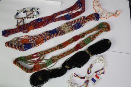 A collection of early 20th century African tribal beaded jewellery, various designs and lengths.