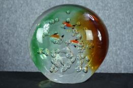 A large and heavy glass paperweight decorated with goldfish. Dia. 19 D.10 cm.