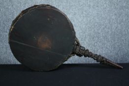 An African hand drum with a carved handle. L.64 cm.